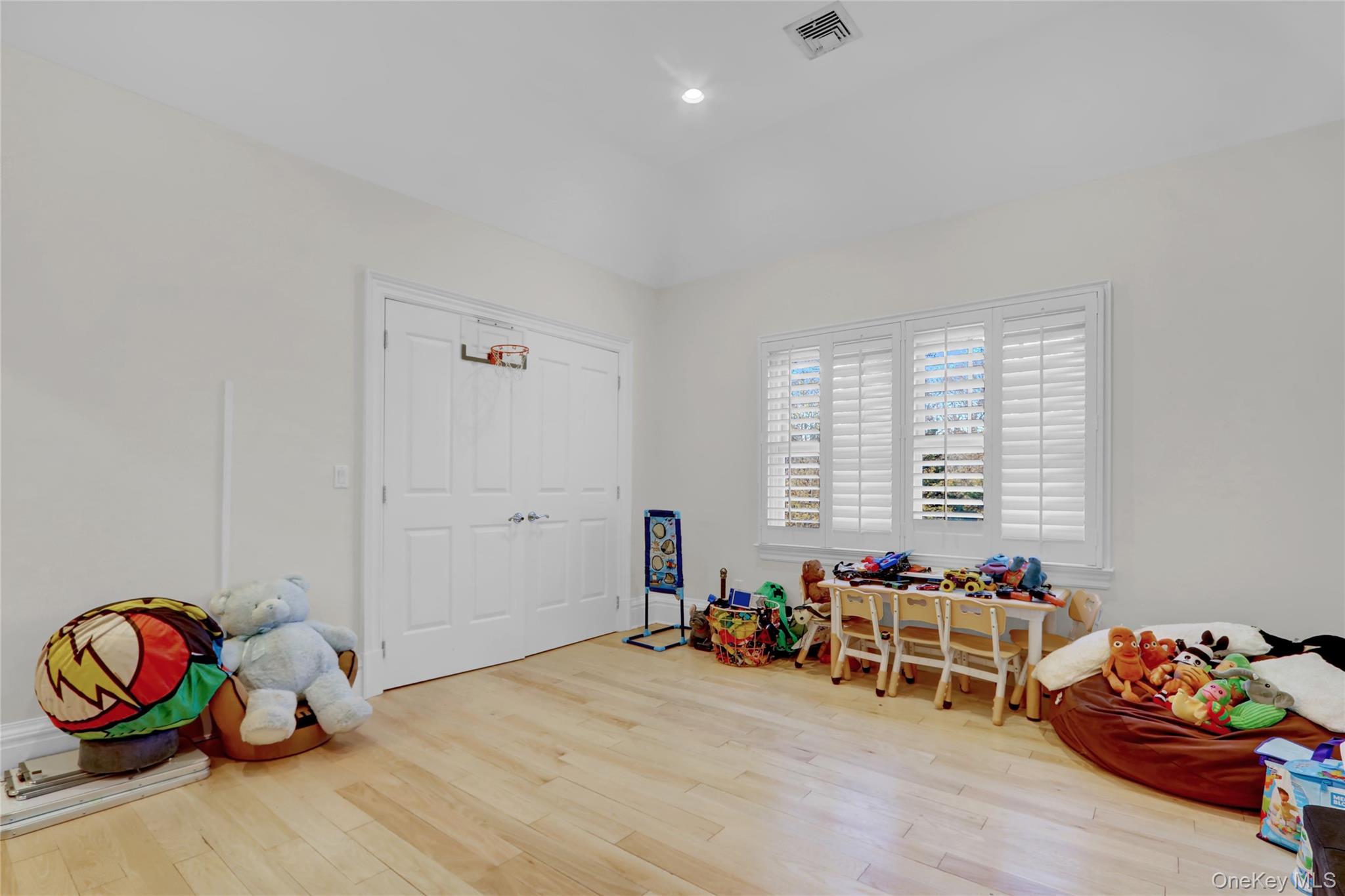 119 Wheatley Road Old Westbury, NY 11568 - Photo 26 of 45 a room with furniture toys and wooden floor