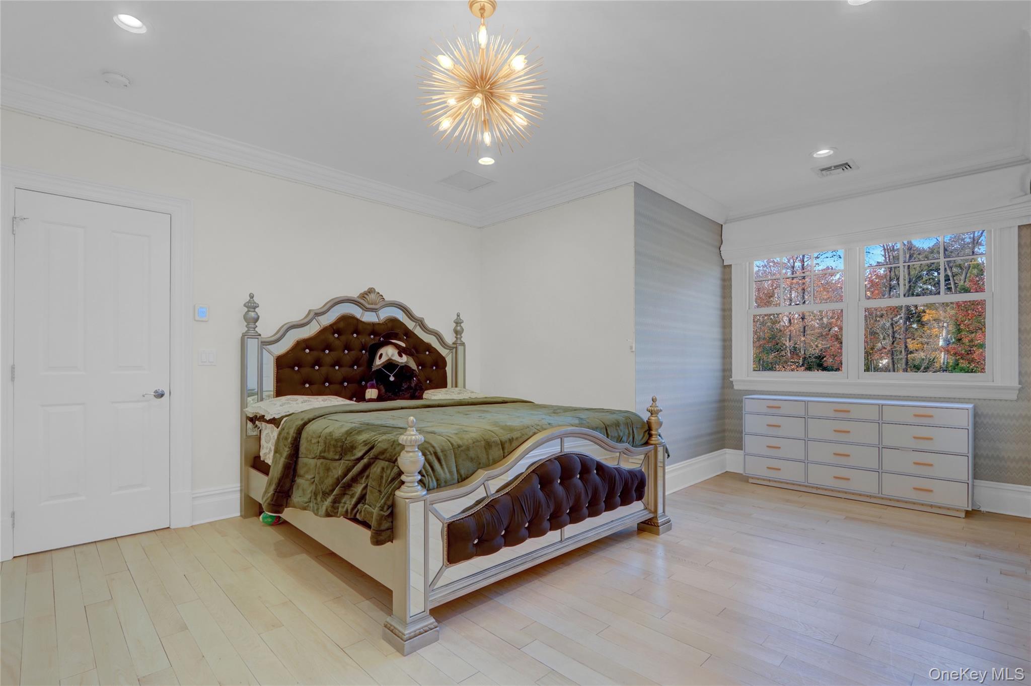 119 Wheatley Road Old Westbury, NY 11568 - Photo 28 of 45 a bedroom with a bed and window