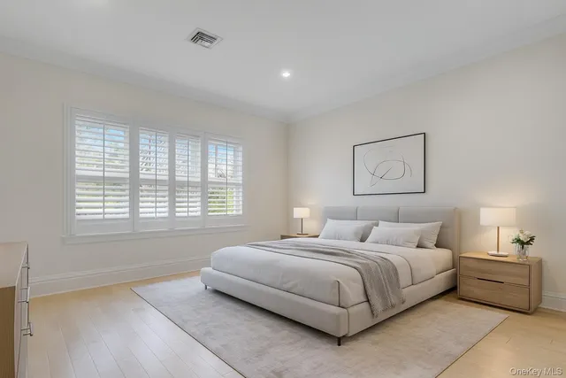 a bedroom with a bed and a potted plant