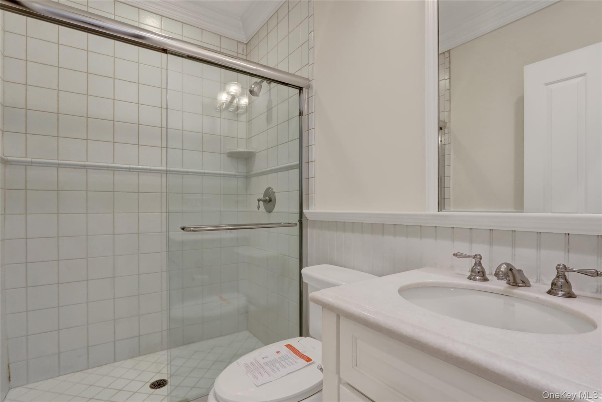 119 Wheatley Road Old Westbury, NY 11568 - Photo 31 of 45 a bathroom with a sink toilet and shower