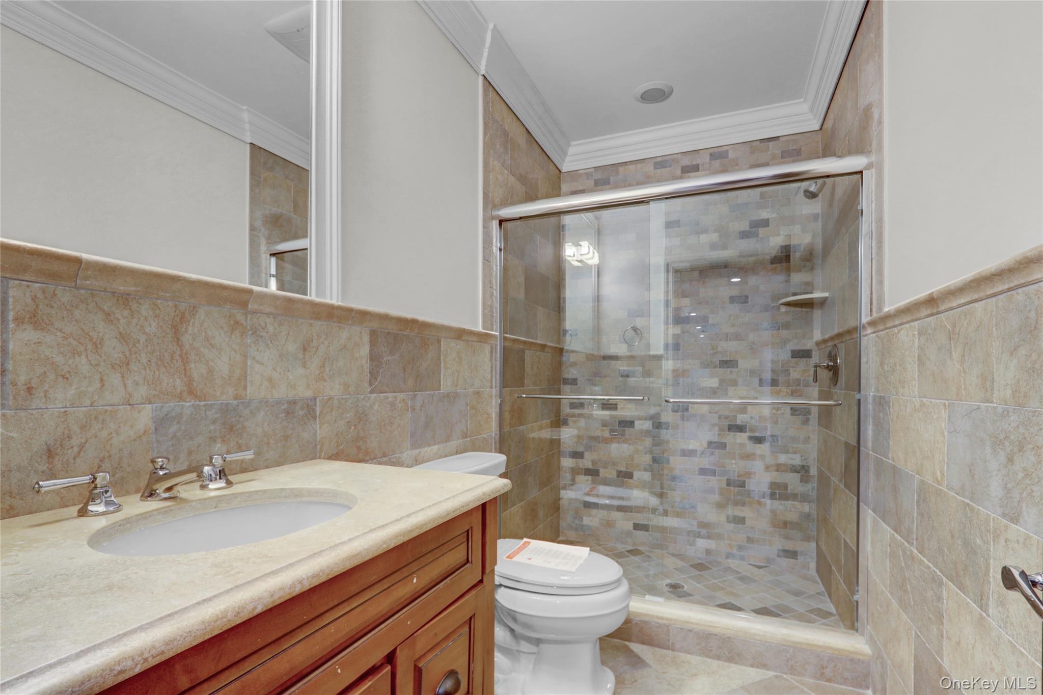 119 Wheatley Road Old Westbury, NY 11568 - Photo 40 of 45 a bathroom with a granite countertop sink toilet and shower