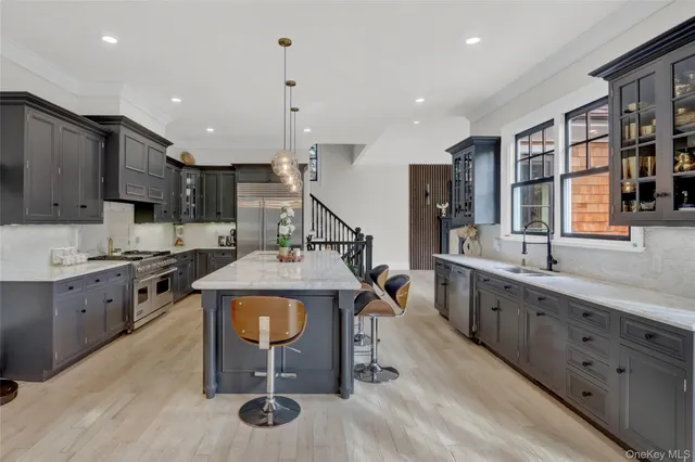 a open kitchen with stainless steel appliances kitchen island granite countertop a sink and cabinets