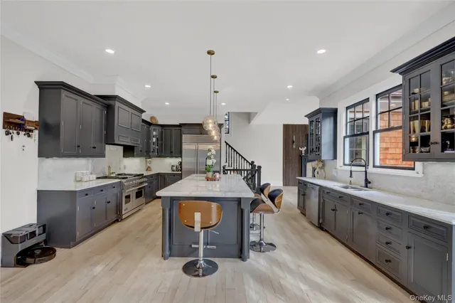 a kitchen with granite countertop a sink stove and refrigerator