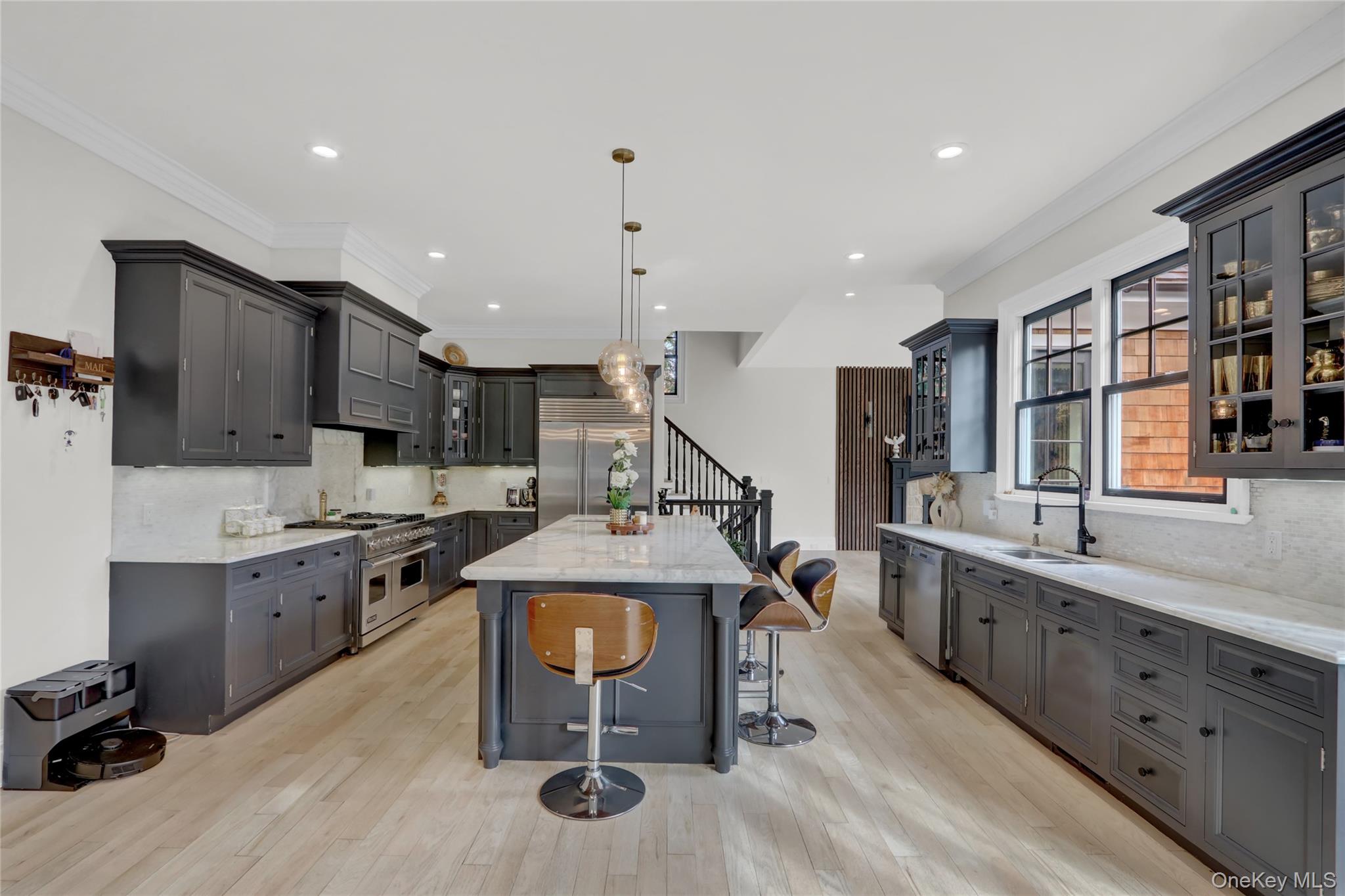 119 Wheatley Road Old Westbury, NY 11568 - Photo 9 of 45 a open kitchen with stainless steel appliances kitchen island granite countertop a sink and cabinets