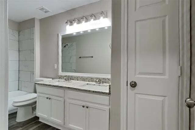 a bathroom with a sink a toilet and a mirror