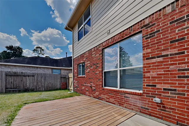 a view of a house with a yard and wooden floor