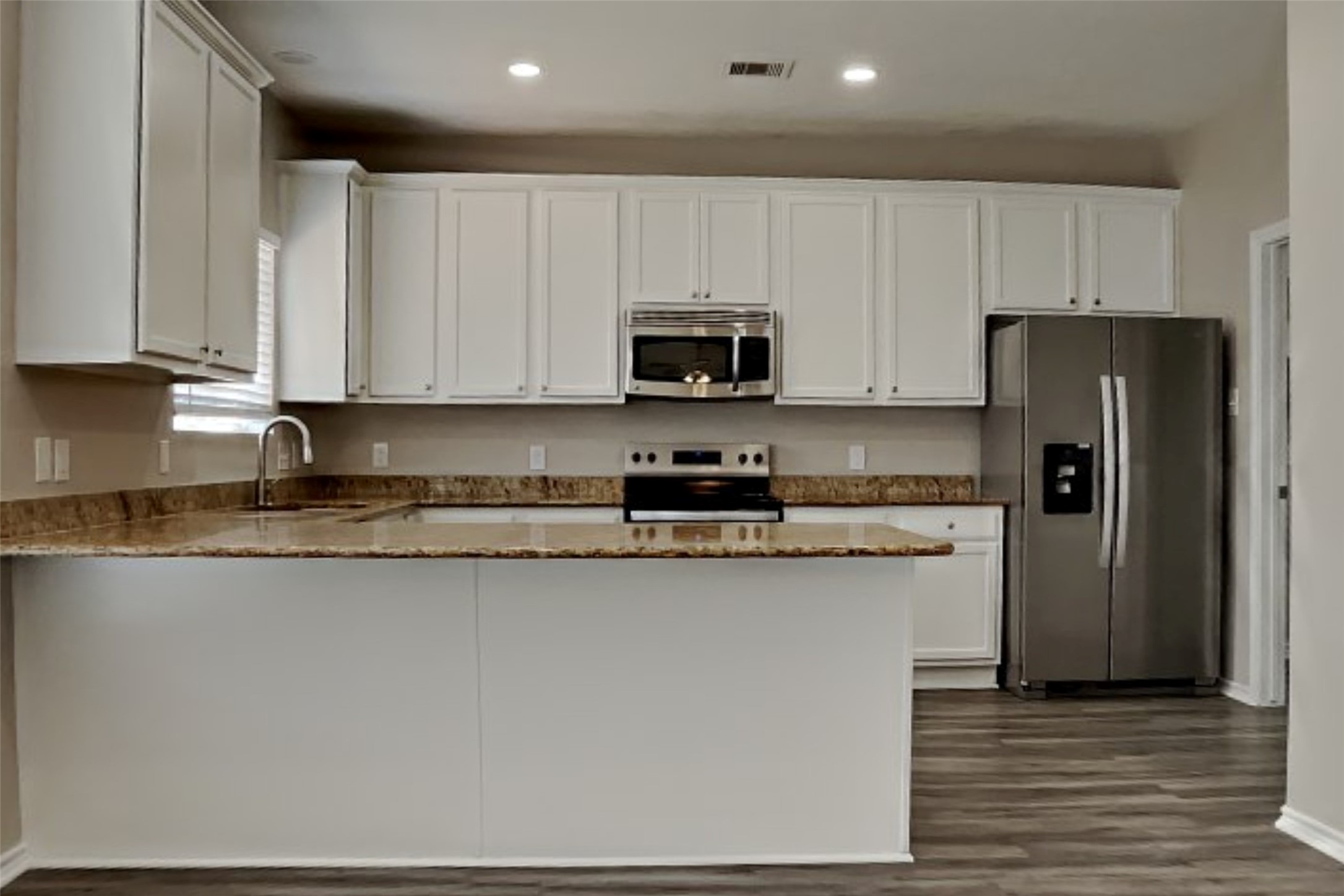 3502 Avalon Spring Lane Spring, TX 77386 - Photo 3 of 20 a kitchen with stainless steel appliances granite countertop a stove a refrigerator a sink and white cabinets