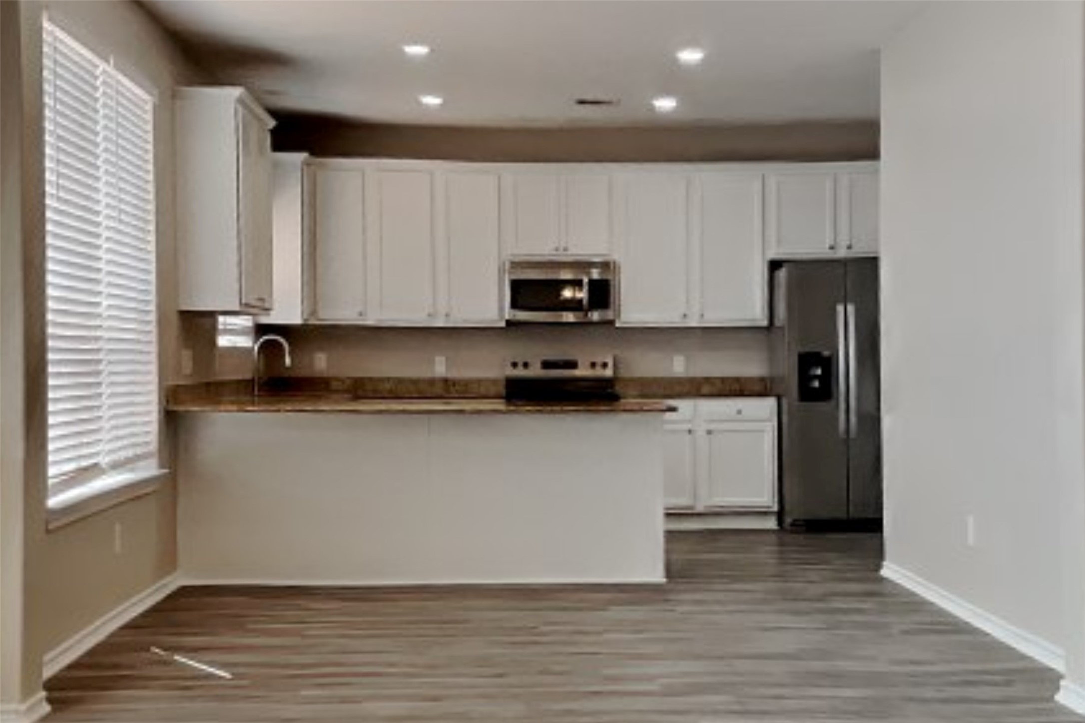 3502 Avalon Spring Lane Spring, TX 77386 - Photo 5 of 20 a kitchen with granite countertop wooden cabinets and a refrigerator