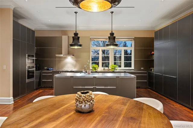 a kitchen with stainless steel appliances granite countertop a sink a counter space and wooden floor