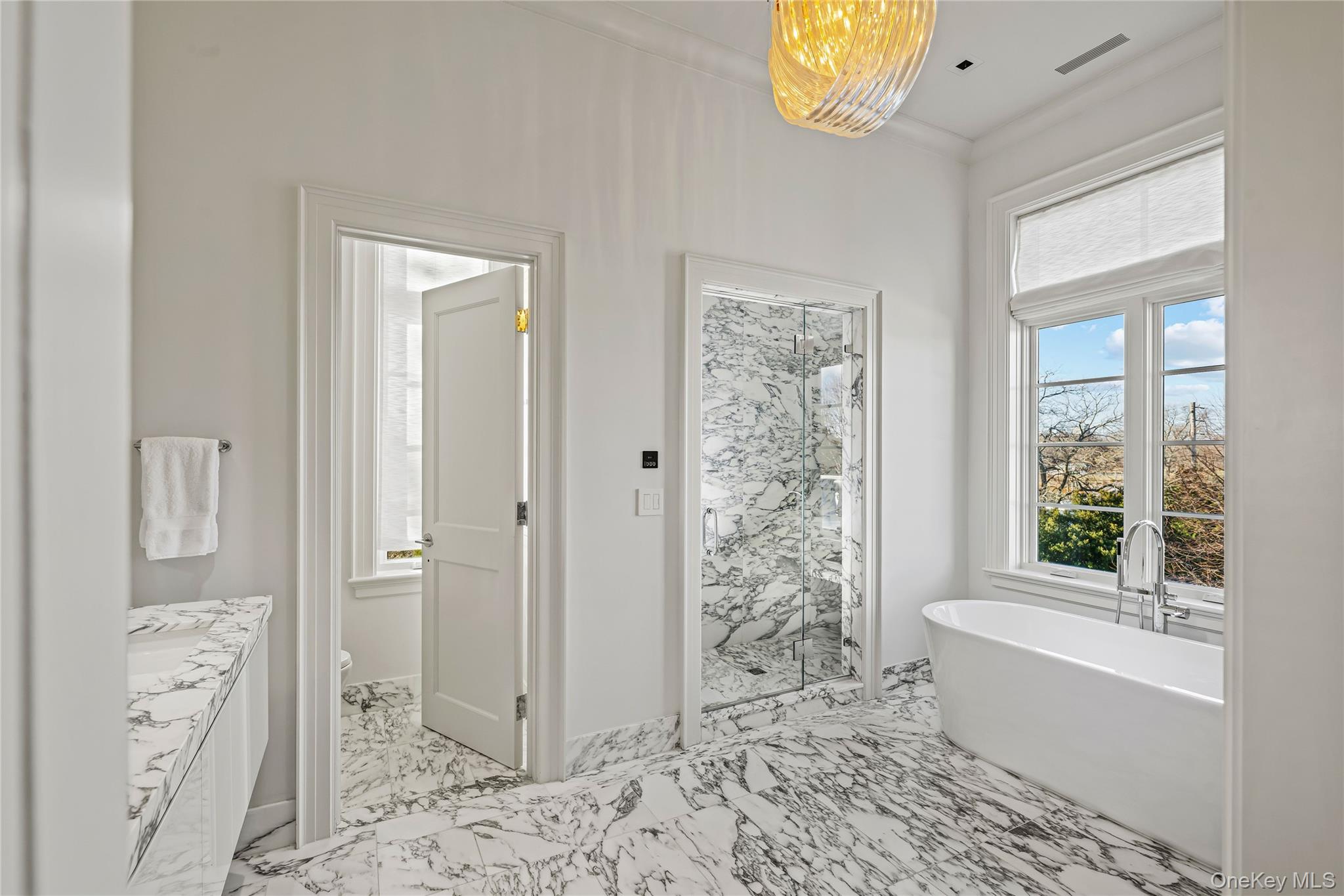 106 Premium Point New Rochelle, NY 10801 - Photo 23 of 44 Full bath with a freestanding tub, a marble finish shower, vanity, and light marble finish flooring