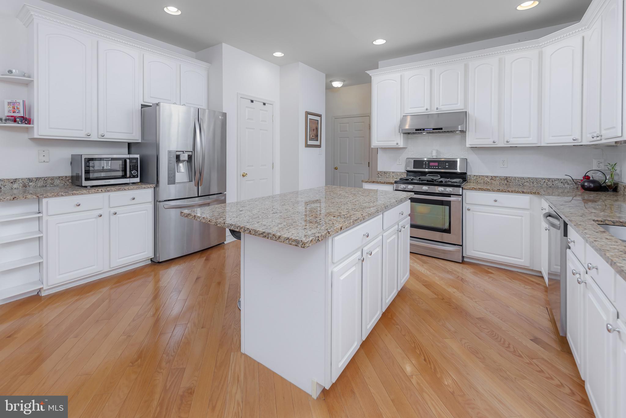 316 Pickwick Drive Williamstown, NJ 08094 - Photo 11 of 44 a kitchen with stainless steel appliances granite countertop a stove a sink and a refrigerator
