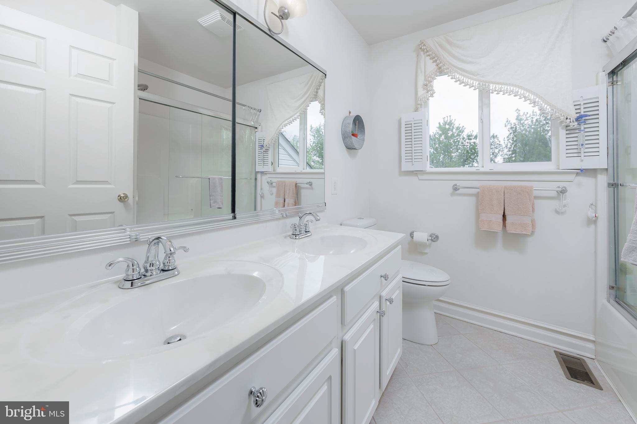 316 Pickwick Drive Williamstown, NJ 08094 - Photo 23 of 44 a bathroom with a sink a toilet and a mirror
