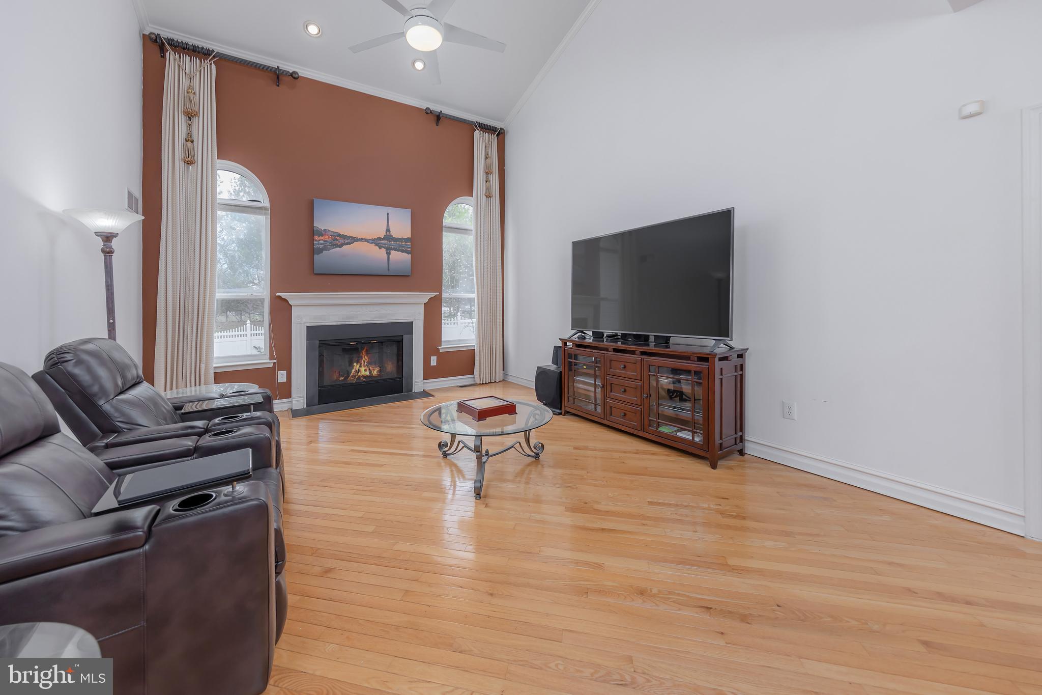 316 Pickwick Drive Williamstown, NJ 08094 - Photo 6 of 44 a living room with furniture a flat screen tv and a fireplace