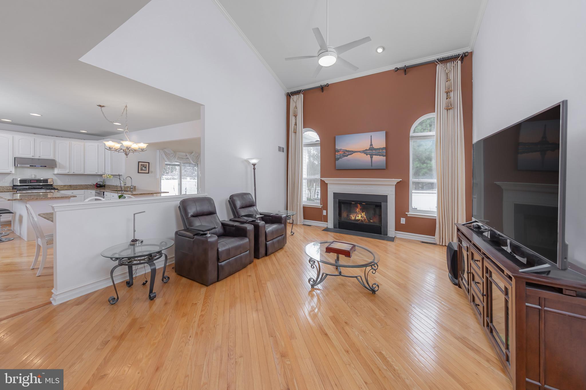316 Pickwick Drive Williamstown, NJ 08094 - Photo 7 of 44 a living room with furniture a flat screen tv and a fireplace