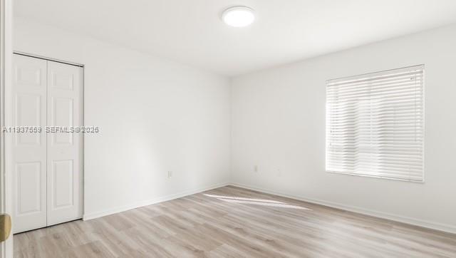 12838 Southwest 47th Street Miramar, FL 33027 - Photo 20 of 40 an empty room with wooden floor and windows