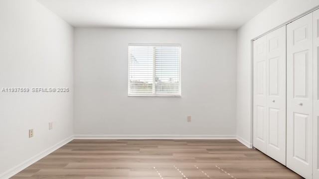 12838 Southwest 47th Street Miramar, FL 33027 - Photo 21 of 40 an empty room with wooden floor and windows