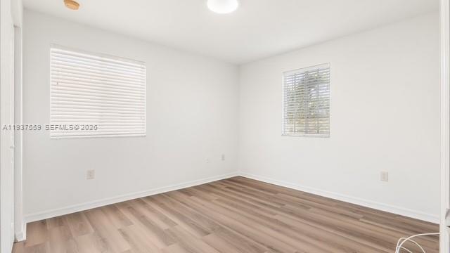 12838 Southwest 47th Street Miramar, FL 33027 - Photo 28 of 40 an empty room with wooden floor and windows