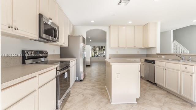 12838 Southwest 47th Street Miramar, FL 33027 - Photo 7 of 40 a kitchen with stainless steel appliances granite countertop a refrigerator stove microwave and sink