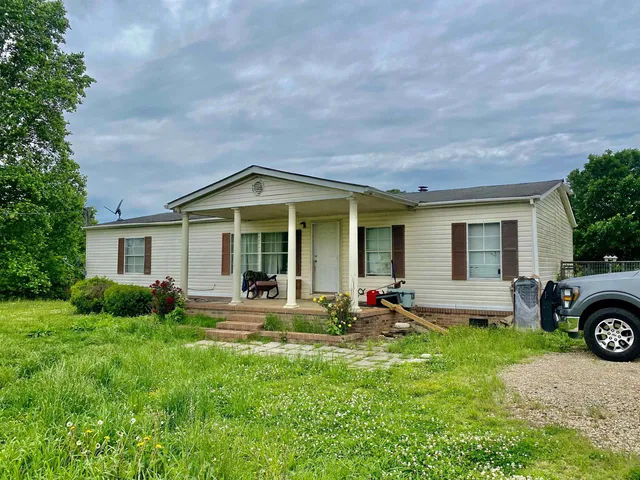 a front view of a house with garden and porch