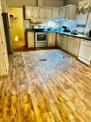 a kitchen with stainless steel appliances granite countertop a sink and a stove