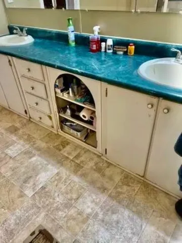 a kitchen with granite countertop a sink and a stove