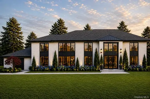 a front view of house with a garden