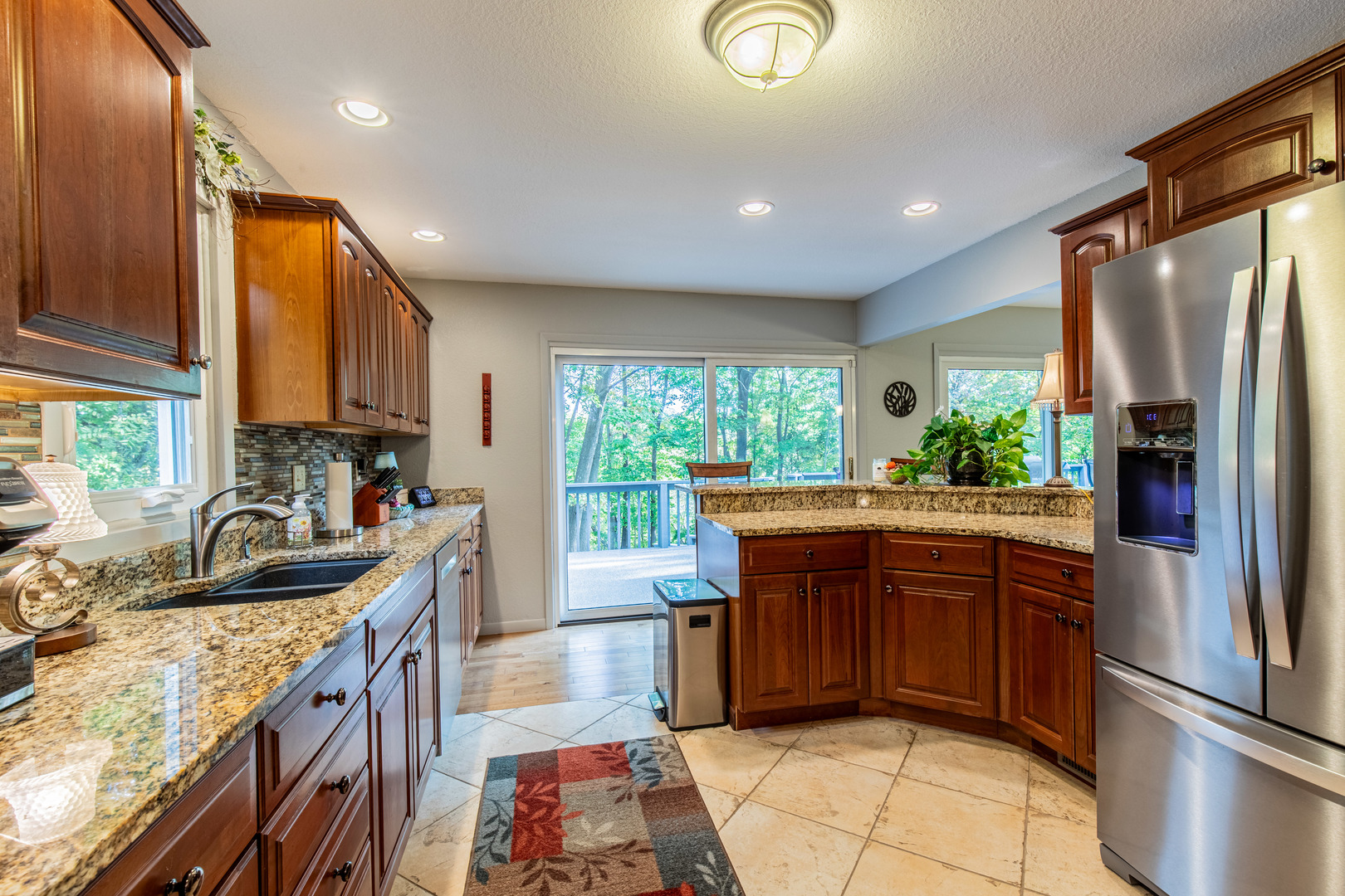 2555 Ridgefield Road Princeton, IL 61356 - Photo 15 of 50 a kitchen with stainless steel appliances granite countertop a refrigerator a sink a stove a washer dryer and a dining table