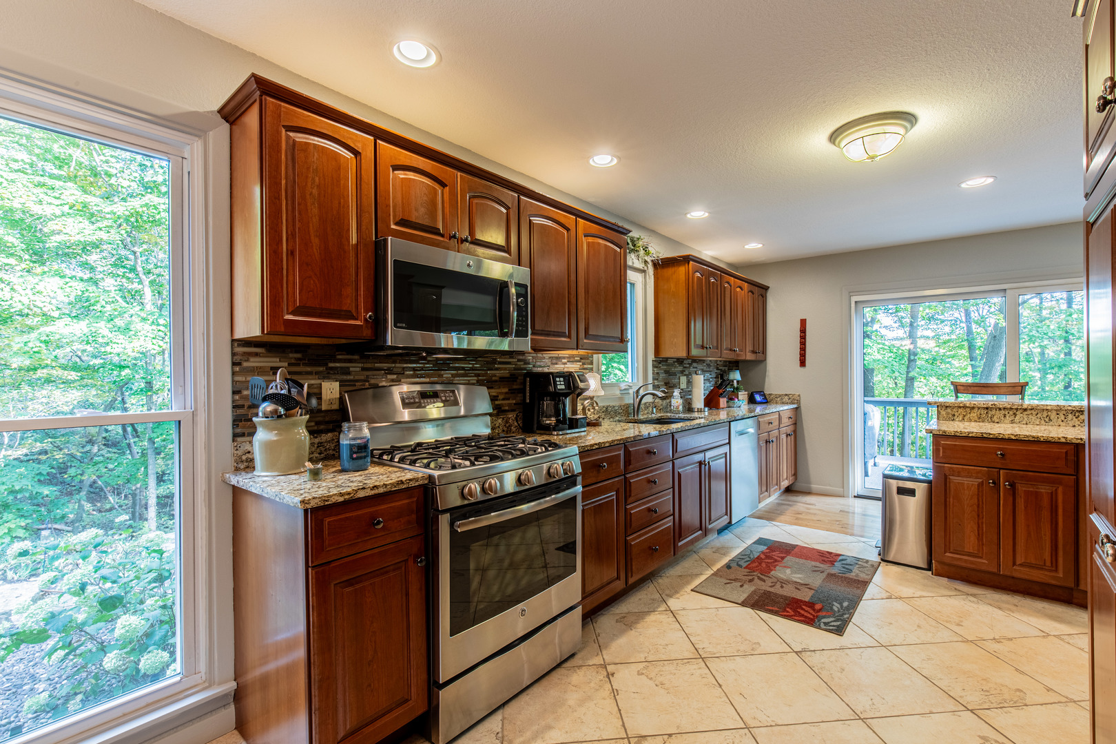 2555 Ridgefield Road Princeton, IL 61356 - Photo 16 of 50 a kitchen with stainless steel appliances granite countertop wooden cabinets a sink and a stove