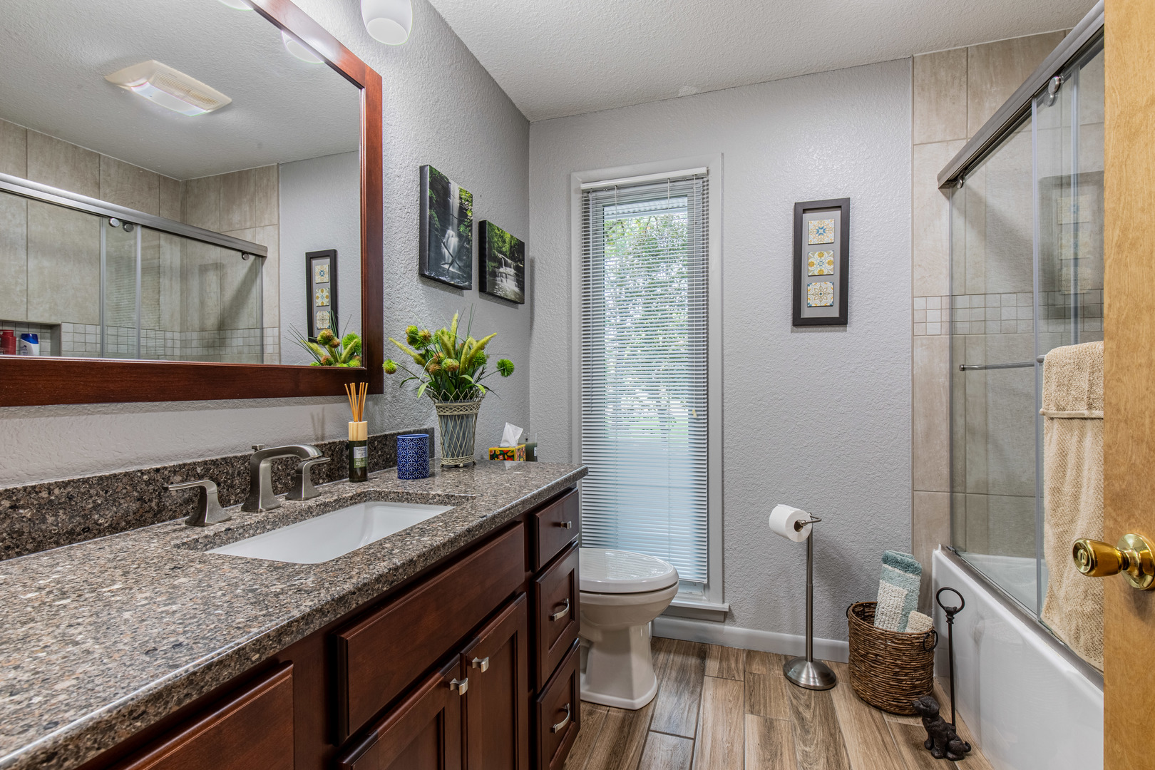 2555 Ridgefield Road Princeton, IL 61356 - Photo 25 of 50 a bathroom with a granite countertop sink a mirror and a toilet
