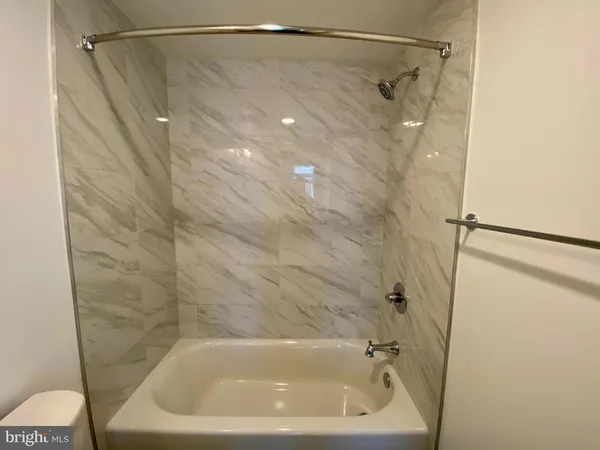 a bathroom with a shower and a bath tub