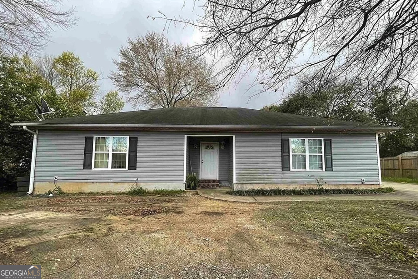 a house that has a tree in front of it