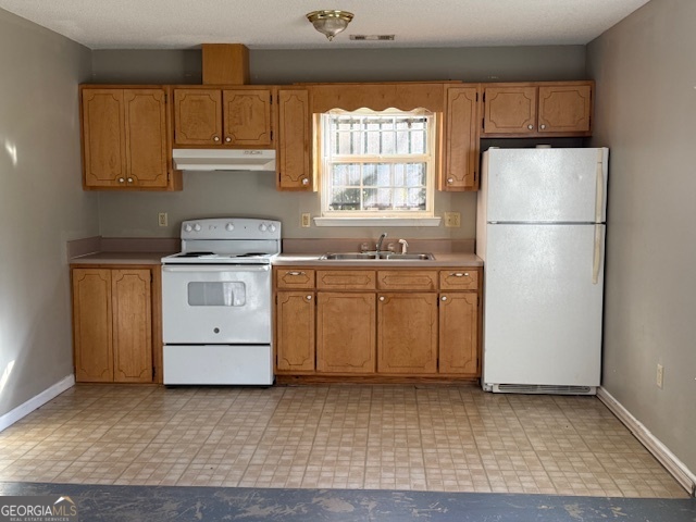 806 East Church Street Fort Valley, GA 31030 - Photo 4 of 4 a kitchen with a stove a sink and a refrigerator