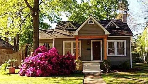 a front view of a house with garden