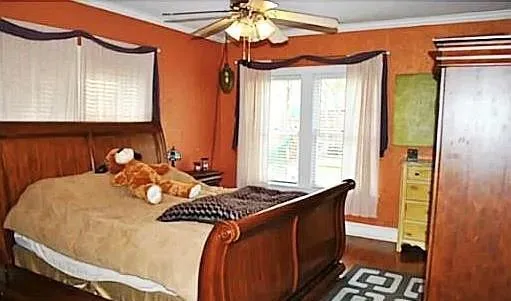 a bedroom with a bed and a chandelier