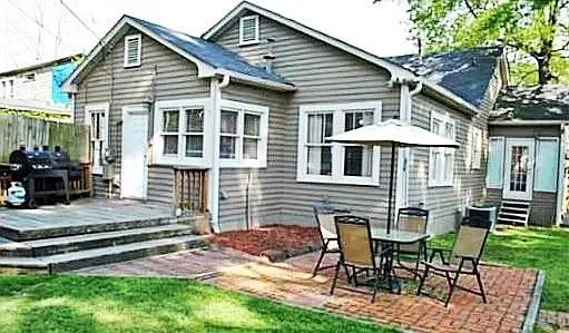 a view of a house with a yard and sitting area