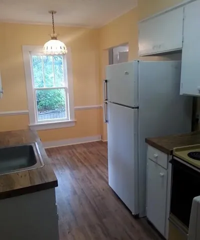 a kitchen with a refrigerator and a sink