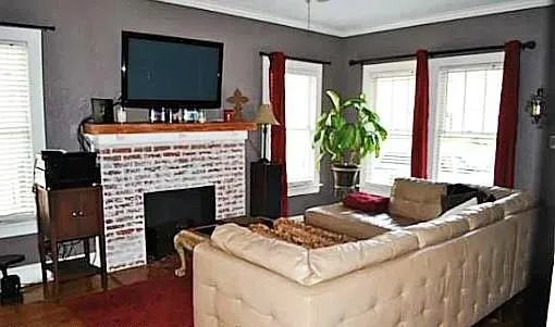 a living room with fireplace furniture and a flat screen tv