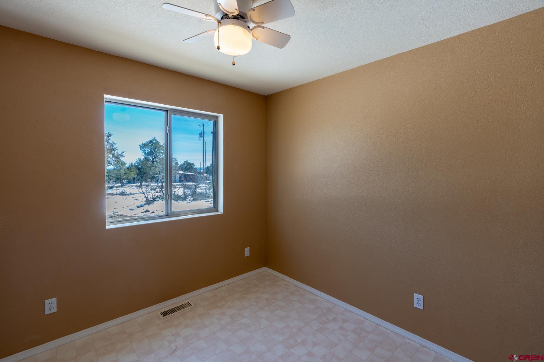 190 Pine Ridge Road Durango, CO 81301 - Photo 14 of 27 an empty room with a window and a ceiling fan