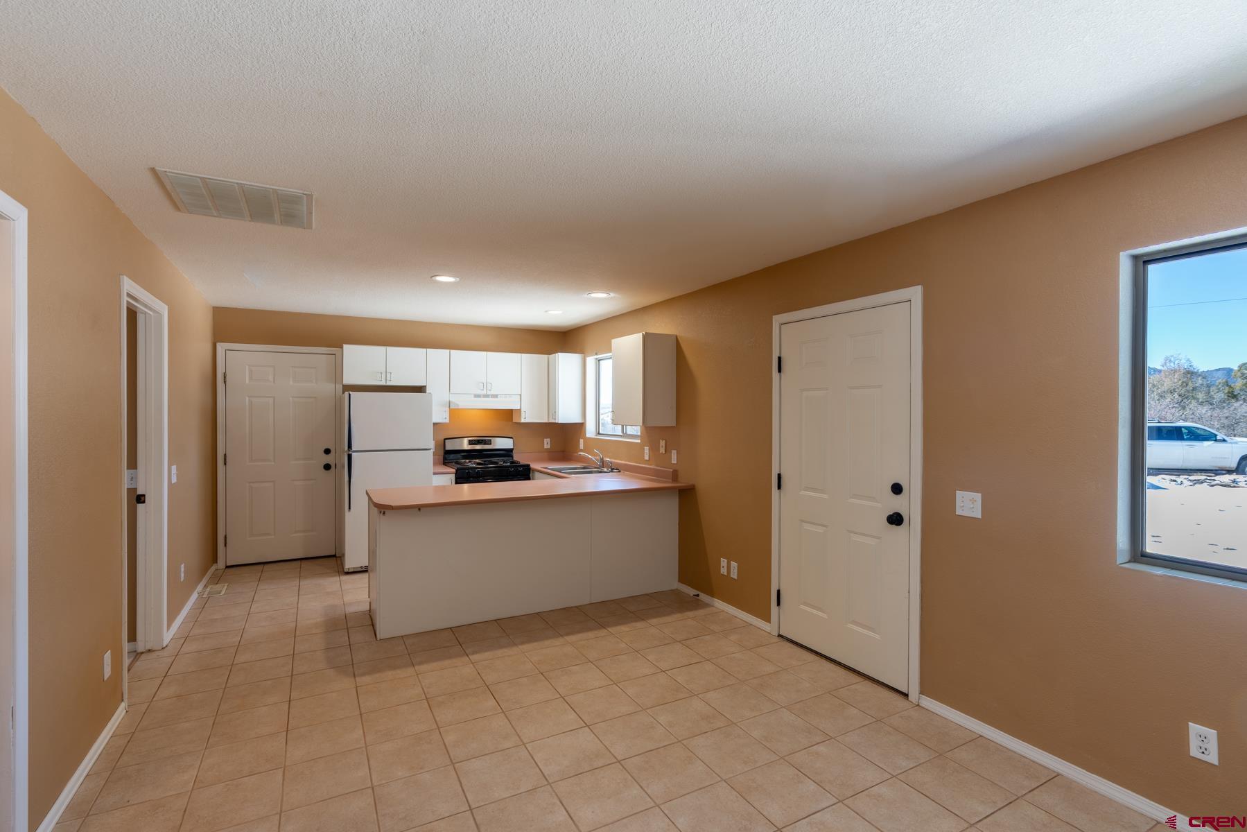 190 Pine Ridge Road Durango, CO 81301 - Photo 17 of 27 a kitchen with a sink and a refrigerator