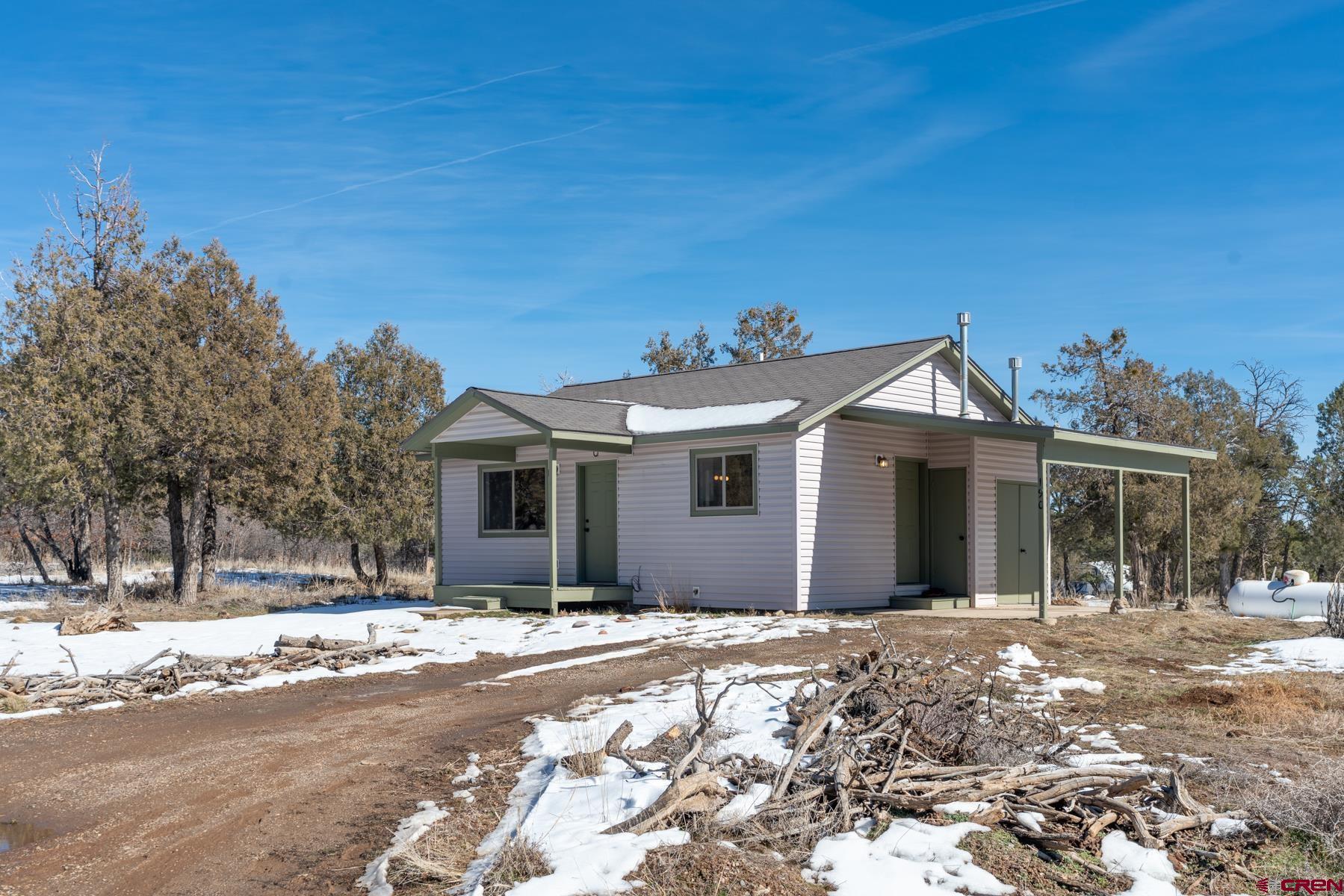 190 Pine Ridge Road Durango, CO 81301 - Photo 27 of 27 a view of a white house with a yard