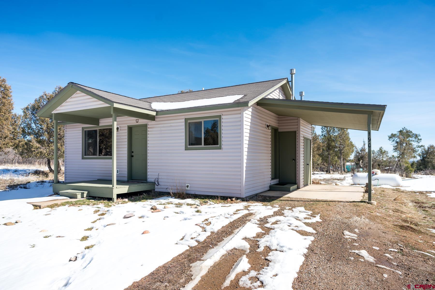 190 Pine Ridge Road Durango, CO 81301 - Photo 3 of 27 a front view of a house with a yard