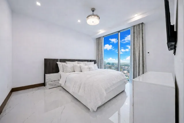 a bedroom with a bed and a painting on the wall