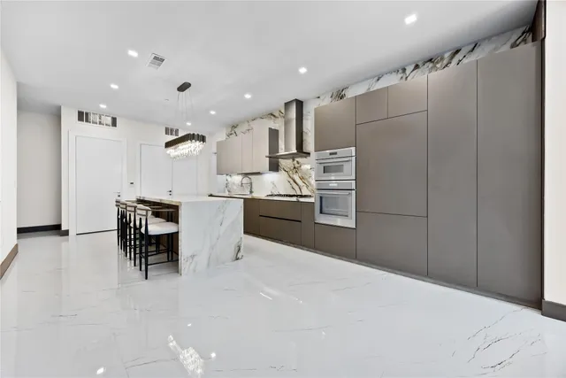 a kitchen with stainless steel appliances kitchen island granite countertop a sink and cabinets