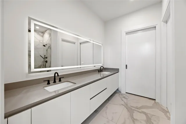 a large kitchen with granite countertop a sink a window and stainless steel appliances