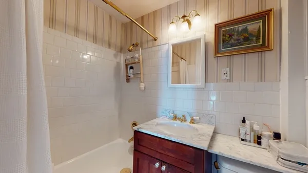 a bathroom with a sink a vanity and a bathtub