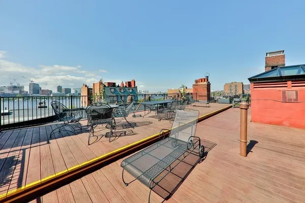 a view of a balcony with two chairs and a wooden floor