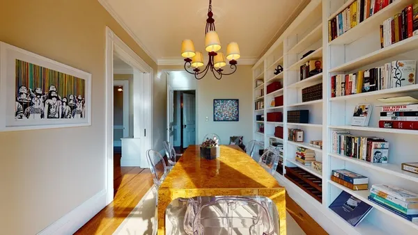 a bedroom with a bed and a book shelf