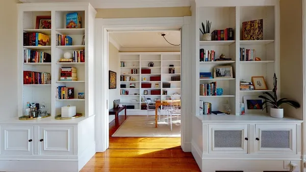 a living room with lots of books and a book shelf