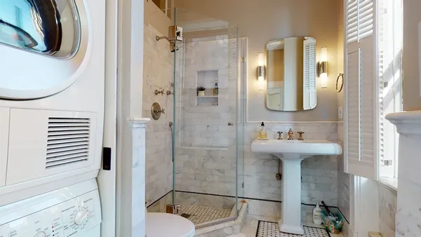 a bathroom with a sink a toilet and shower