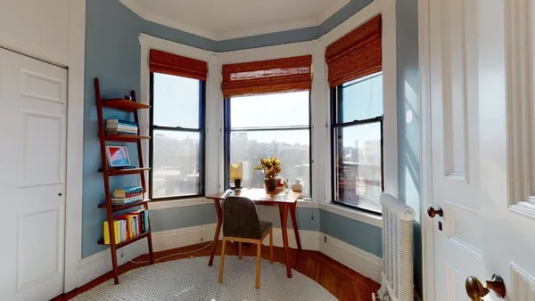 a dining room with furniture and a window